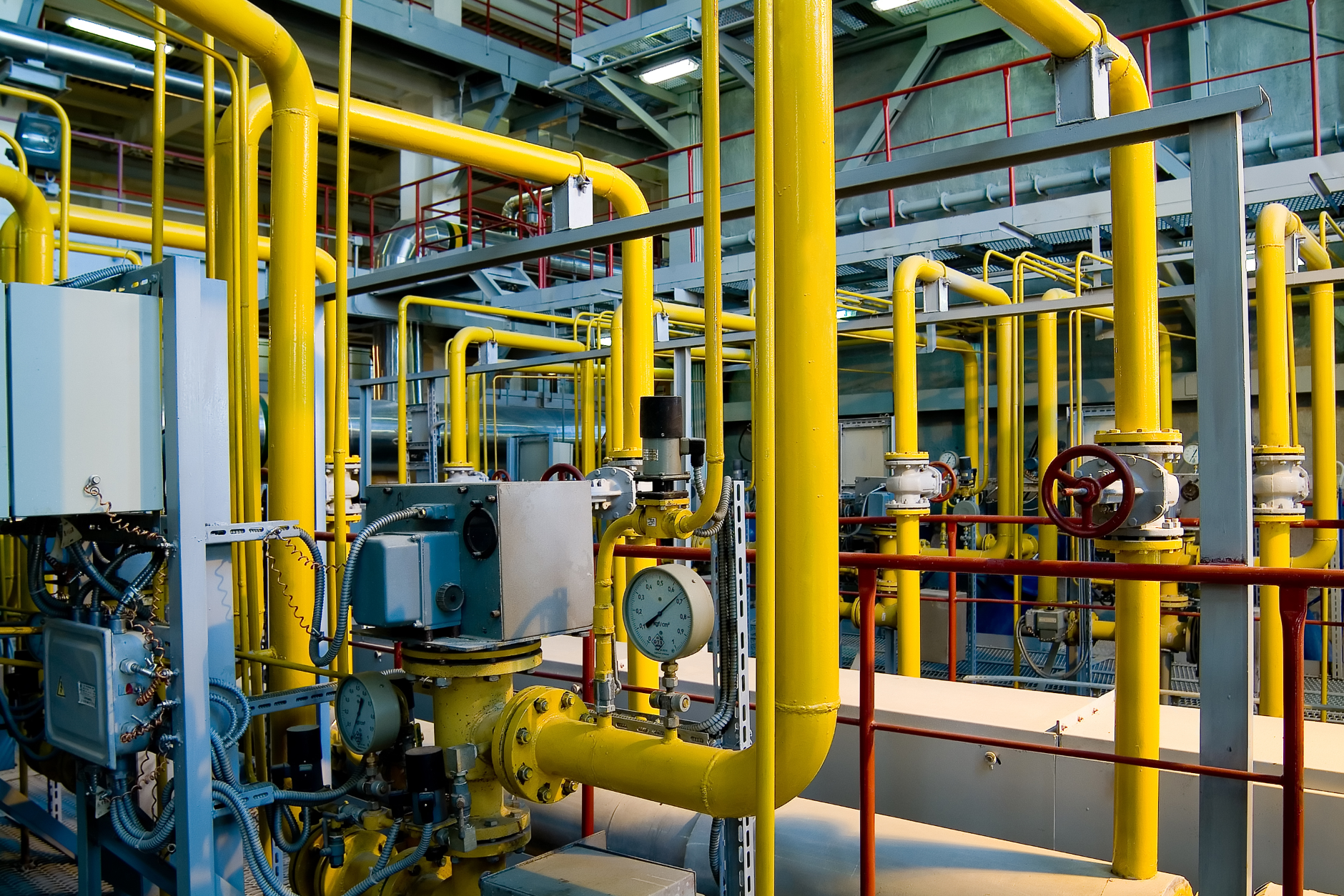 Complicated air compressor system with yellow and red pipes.