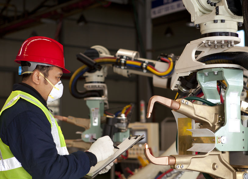 Technician checking robot machine
